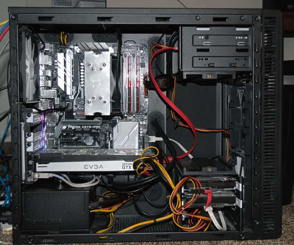 A photo of the new CPU, heatsink, RAM, motherboard, SSD, and PSU.