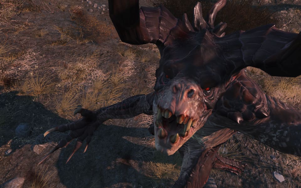 Screenshot of a deathclaw holding you up in the air, ready to dig its claw into your gut.