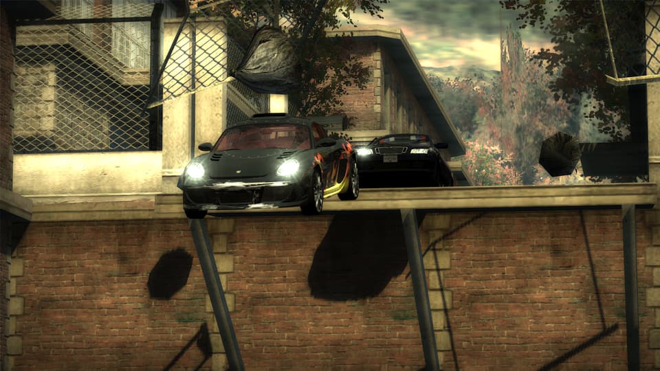 Screenshot of Need For Speed Most Wanted, catching some air with the cops.