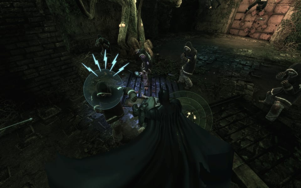 Screenshot of Batman beating up some more goons, but illustrating that one is about to make a move that you can counter.