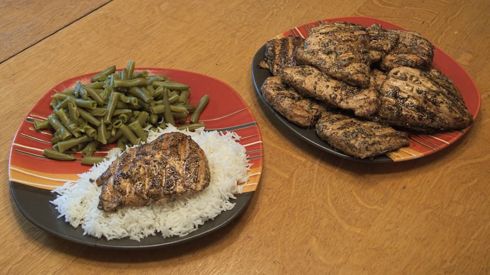 Grilled chicken on a plate with rice and green beans